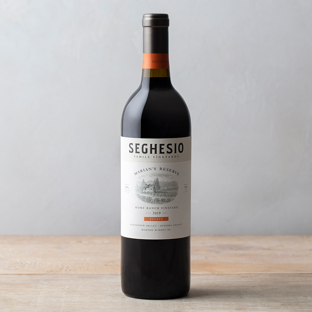 2019 Marians Reserve wine bottle on wood table with grey background
