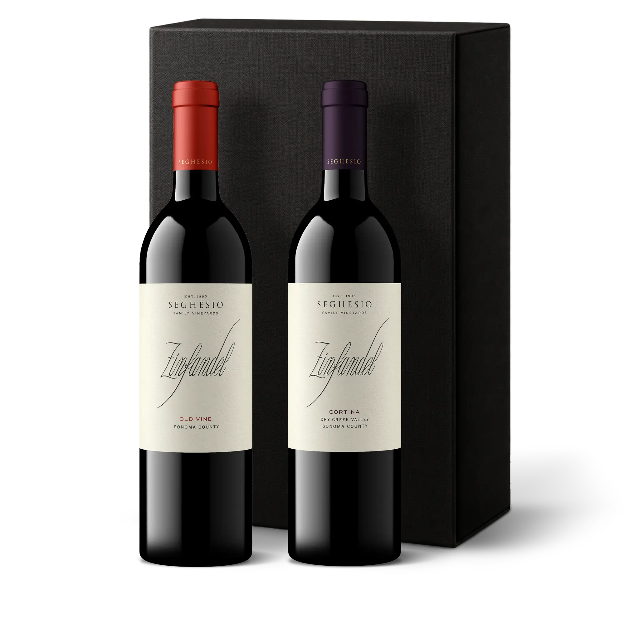Two bottles of Premiere Sonoma Zinfandels, each adorned with a different colored foil (one red and one purple), are elegantly placed in front of a sleek black gift box on a pristine white background. This 2-Bottle Gift makes an impressive presentation for any wine enthusiast.
