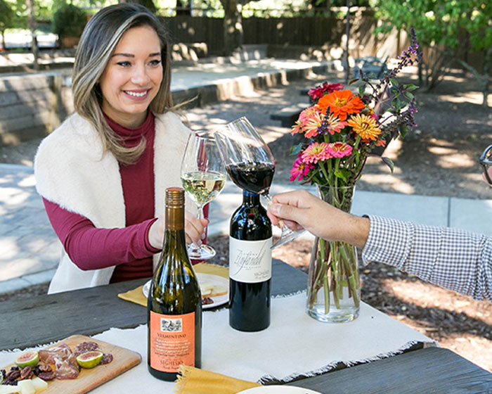 Couple enjoying picnic and wine at Seghesio Family Vineyards