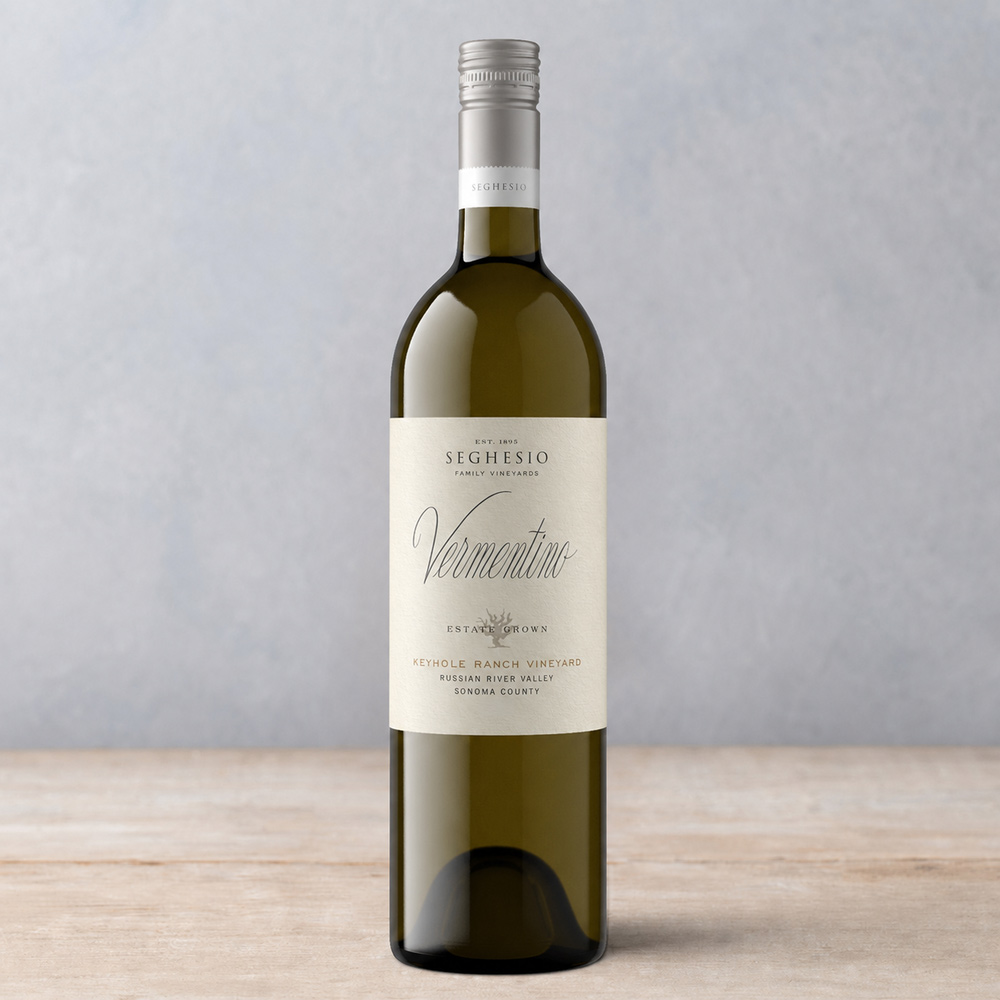 A bottle of Seghesio Family Vineyards Vermentino white wine stands on a light wooden surface against a pale, textured background, perfectly showcasing the elegance of Vermentino.