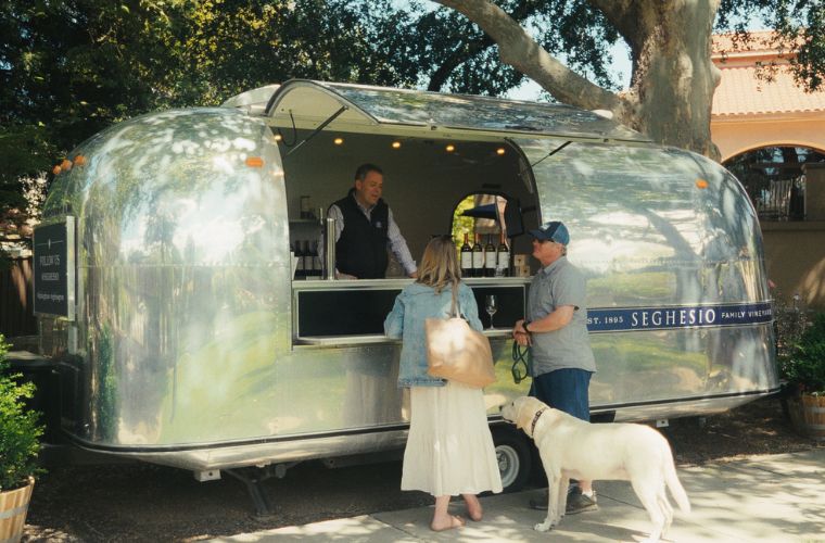photo of Seghesio employee serving wine out of the airstream.