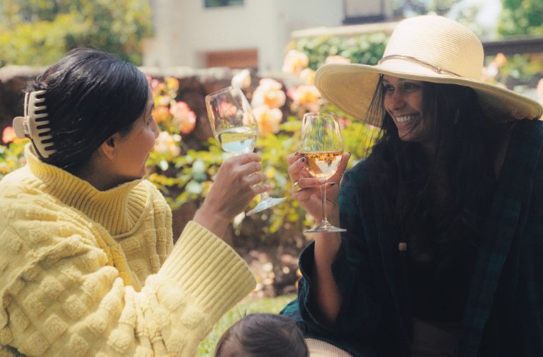 Photo of two women enjoying wine in the grove at Seghesio.